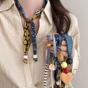 Detail view of Korean style ribbon necklace with wooden beads and cute heart pendant.