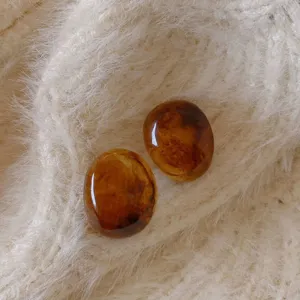 Retro amber resin stud earrings for women, elegant oval design, vintage jewelry style.