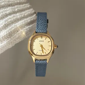 IEKE women's polygon quartz watch with gold dial and stylish blue leather strap detail.