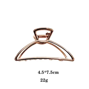 Molla per capelli in metallo oro rosa, dettaglio 4.5x7.5cm, accessorio geometrico elegante.