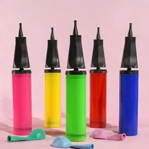 Colorful plastic balloon hand pump detail shot, portable inflating tool for party decorations.