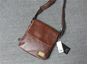 Brown leather messenger bag detail, vertical crossbody strap view, high quality PU leather.