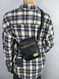 Detail view of Three-box fashion vertical cross-body bag worn on back, casual daily use.