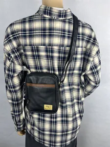Casual vertical crossbody bag with black PU leather and contrast brown stripe design.