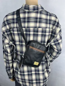Men's fashion vertical crossbody small bag black leather casual shoulder bag detailed view.