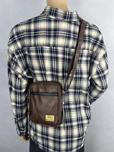Brown vertical crossbody bag for daily casual use, featuring a compact design and shoulder strap.