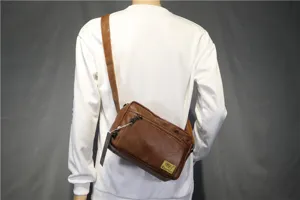 Brown PU leather casual cross-body bag for men, featuring adjustable strap and zipper pocket detail.