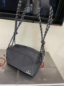 Black canvas crossbody bag for men and women, casual commuter shoulder bag with rope straps.