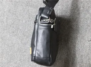 Detail view of men black PU leather messenger bag side profile with shoulder strap hardware.