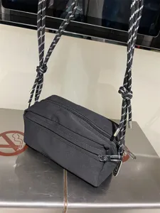 Black canvas crossbody bag with speckled rope straps, casual daily shoulder bag for commuting.
