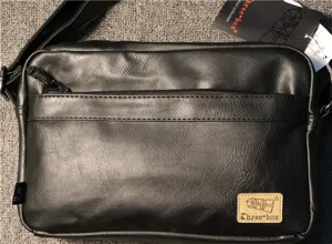 Black leather shoulder bag for men, casual crossbody messenger bag with front zipper pocket.