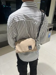 Casual canvas crossbody bag for men and women, stylish shoulder commuter bag in khaki.