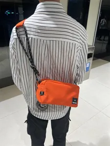 Canvas crossbody bag for men and women, trendy orange messenger bag with rope strap daily use.