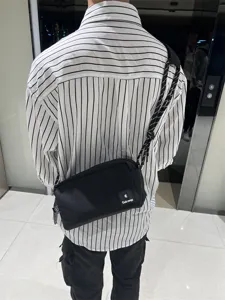 Casual black canvas crossbody bag for men and women, featuring stylish thick braided strap.