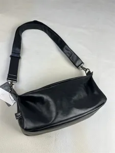 Black minimalist retro PU leather messenger shoulder bag detail shot with wide strap