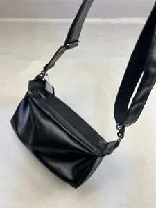 Black leather crossbody bag with adjustable wide strap and zipper closure for casual daily wear.