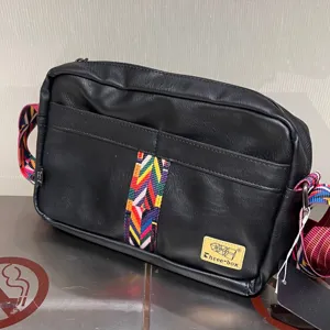 Retro casual men's crossbody bag soft leather shoulder bag with ethnic woven strap design.
