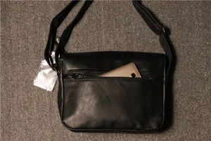 Detail shot of retro men's black PU leather shoulder crossbody bag with zipper back pocket.