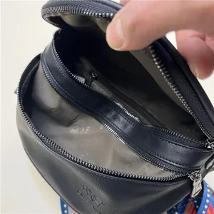 Threebox fashion black leather spherical shoulder bag with multi-zipper and colorful strap.