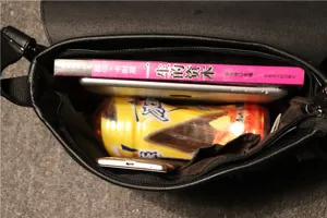 Interior detail view of the black retro shoulder bag, showcasing spacious capacity and storage.
