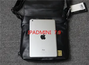 Detailed view of the black leather vertical messenger bag, showing size compatibility with iPad.