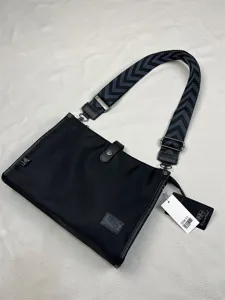 Men's fashion nylon crossbody bag with wide patterned strap and zipper closure, black.