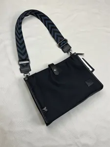 Black nylon crossbody bag for men, stylish messenger bag with patterned wide strap.