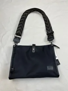 Three-box black nylon crossbody shoulder bag with stylish geometric patterned wide strap.
