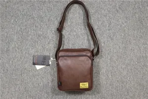 Detailed view of the brown PU leather vertical shoulder bag, showing texture and strap.