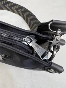 Threebox men's nylon crossbody bag detail showcasing durable zipper hardware and strap.
