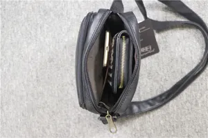 Interior detail shot of black men's vertical shoulder bag showing spacious storage compartments.