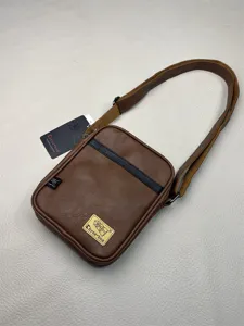 Stylish brown PU leather vertical crossbody bag with shoulder strap and brand label.
