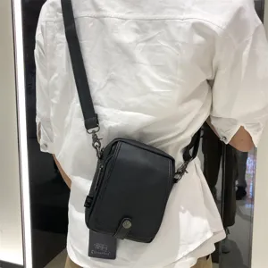 Black vertical crossbody bag for men and women, casual PU leather shoulder bag for daily use.