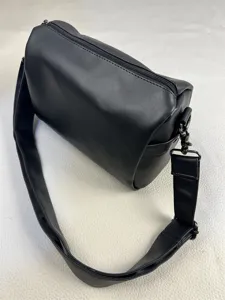 Detailed view of minimalist black crossbody shoulder bag, casual style for men and women daily use.