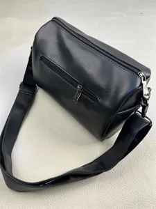 Black leather cylindrical shoulder bag, minimalist casual messenger bag with wide strap.