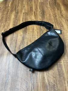 Men black PU leather croissant crescent sling bag detail view, vintage commuter crossbody.