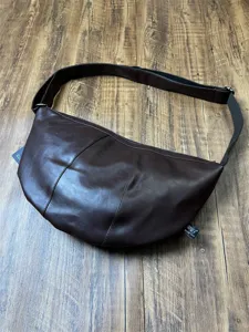 Threebox retro brown leather crescent crossbody bag for men and women commuting daily use.