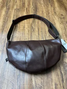 Dark brown leather crescent shoulder bag, vintage casual crossbody dumpling bag for daily commute.