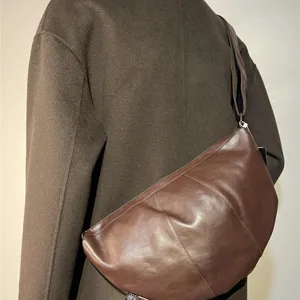Brown leather crossbody dumpling bag for men and women, stylish retro commuter shoulder bag.