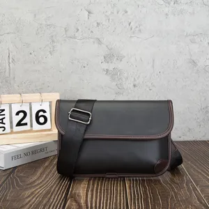Detailed shot of a vintage style men's messenger bag with adjustable strap and soft leather.