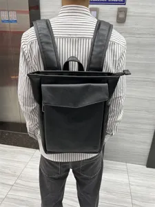 Detailed back view of a sleek black leather backpack for daily travel, campus, and outdoor use.