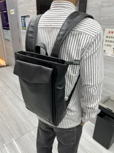 Stylish black leather backpack for men and women, casual student schoolbag and travel daypack.