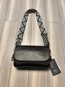 Detail view of the casual men crossbody bag showing texture, black PU leather and strap.