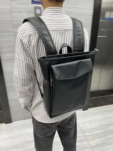 Black PU leather backpack for men, casual student schoolbag and travel laptop daypack.