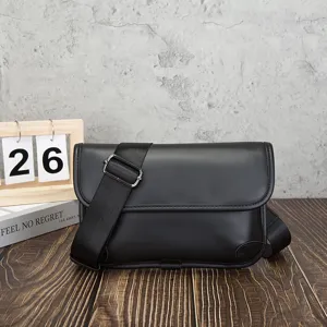 Detail shot of black soft leather men retro crossbody messenger bag with wide strap.