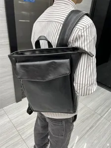 Black faux leather backpack detail view, casual school bookbag and travel daypack for men women
