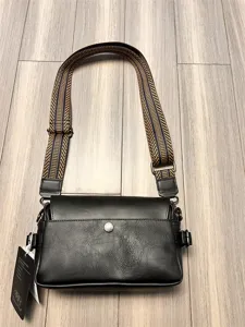 Stylish black crossbody bag for men with patterned wide strap and convenient front flap pocket.