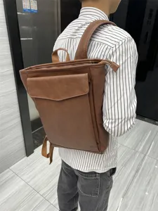 Casual brown PU leather backpack for men and women, stylish school bag for travel and daily use.
