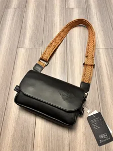 Detailed view of the stylish men's black PU leather crossbody bag with wide patterned strap.