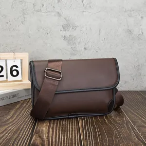 Detailed view of the dark brown men leather messenger bag, showing soft PU texture and strap.